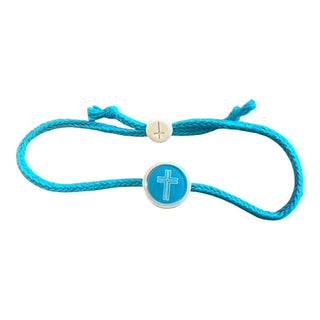 A turquoise blue cord bracelet featuring a round blue and white cross charm in the center and an adjustable silver-tone sliding button.