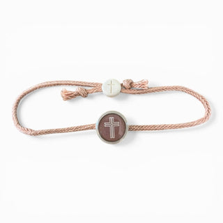 Bracelet with cross charm on a white background