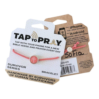 Pink bracelet with a tag explaining its function and branding details.