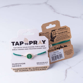Bracelet with 'Tap to Pray' packaging on a marble surface
