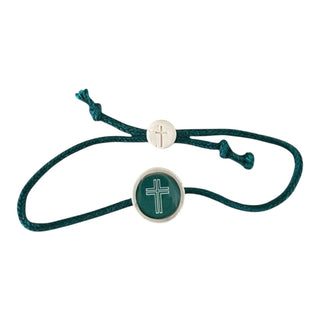 Green bracelet with silver cross charm on a white background