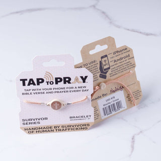 Bracelet with 'Tap to Pray' packaging on a marble surface