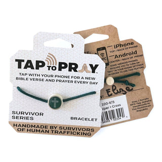 Green bracelet with a cross charm on a branded card, displayed against a white background.