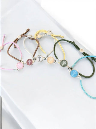 Set of colorful bracelets with beads on a white surface