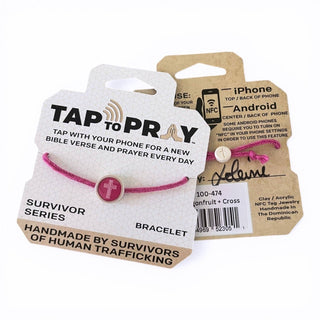 Pink bracelet with a religious charm on packaging labeled 'Tap to Pray'.