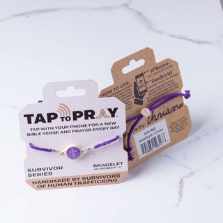 Purple bracelet with 'Tap to Pray' packaging on a white background