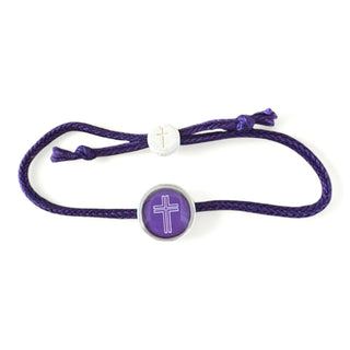 Purple bracelet with a white bead and cross charm on a white background