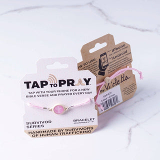 Pink bracelet with 'Tap to Pray' packaging on a white background
