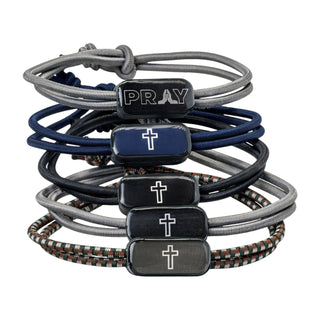 Set of braided bracelets with prayer and cross charms on a white background