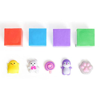 A set of colorful, squishy mini toys and small blocks on a white background, including a red block, a blue block, a purple block, a green block, a yellow chick, a white bear with a pink bow, a pink swirl lollipop, a purple penguin, and a pink paw print.
