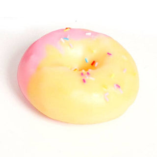 A novelty squishy toy shaped like a donut, featuring a two-tone pink and pale yellow glaze with colorful sprinkles, on a plain white background.