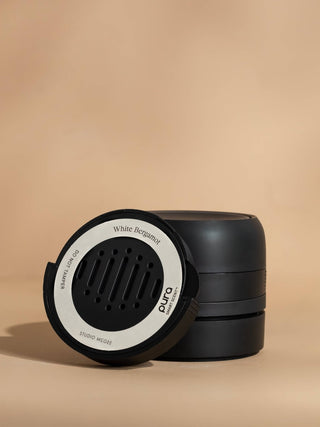 Black and white container with 'White Bergamot' branding on a beige background