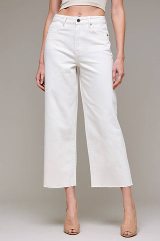 White wide-leg jeans worn by a person on a plain background