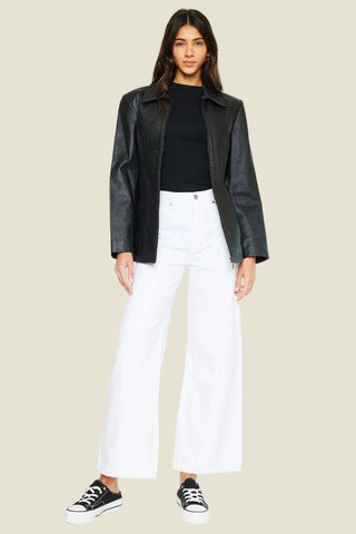 The White Label 90's Ultra High-Rise Wide Leg Jeans in white, styled with a black leather jacket