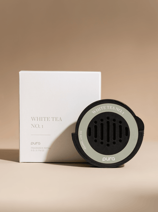 Pura white tea diffuser and packaging on a beige background
